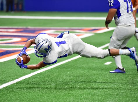 Essential Roster Moves for the Buffalo Bills Football player making an incredible diving catch during a high-energy game in the stadium.